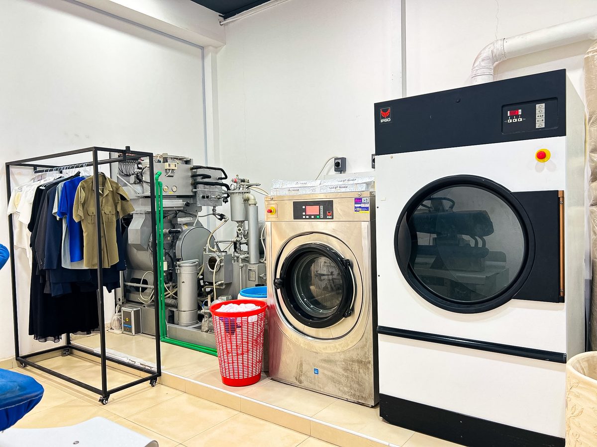 Dry cleaning machines and garments at Alwaab Laundry Express