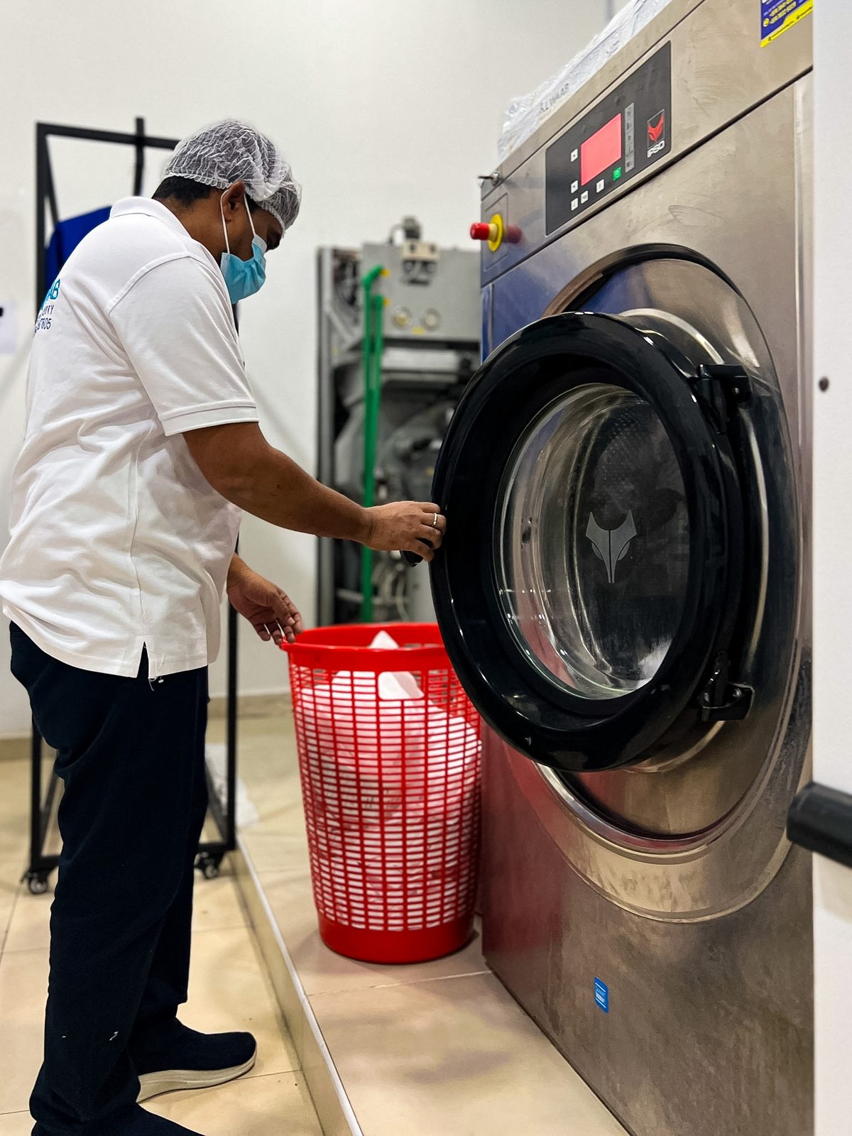 Loading garments into a professional washing machine
