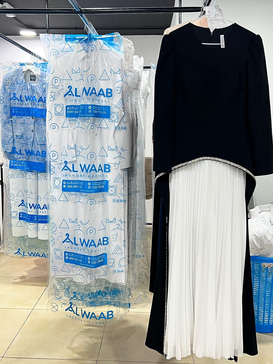 Freshly dry-cleaned garments in Alwaab covers